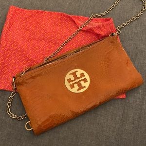 Orange convertible purse with gold medallion